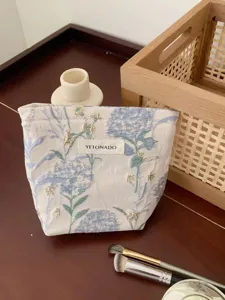 Portable floral cosmetic bag for travel, large capacity makeup pouch with elegant floral pattern.