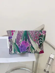 Detailed view of large capacity embroidered floral cosmetic pouch, portable toiletry travel bag.