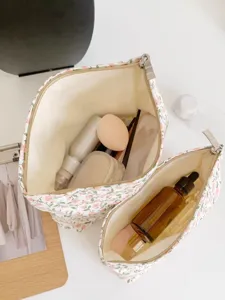 Close up detail showing interior capacity of floral cosmetic bag, convenient travel storage pouch.