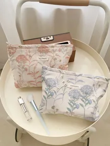 Exquisite floral embroidered cosmetic pouch detail, portable travel makeup storage bag with zipper.