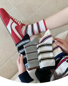 Details of women's retro striped slouchy socks, stylish color-blocking mid-tube design.