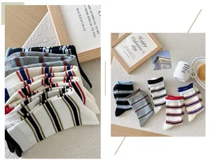Detailed view of women colorful striped rolled cuff socks, Korean style cozy casual footwear.