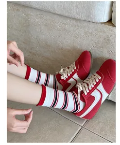 Retro striped mid-calf socks detail shot, showing stackable rolled cuff and colorful design.
