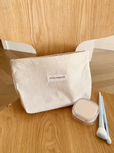 Detail view of the solid color corduroy cosmetic bag showcasing its texture and large storage capacity.