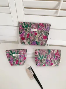 Detailed view of floral tapestry cosmetic bag set, compact travel pouch with secure zipper.