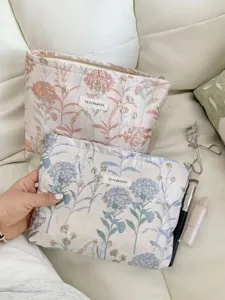 Detailed view of the floral jacquard cosmetic pouch showcasing exquisite fabric and quality zipper.