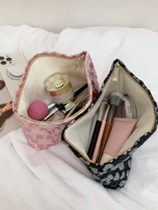 Detailed view of large capacity heart quilted cosmetic bag with organized makeup inside.