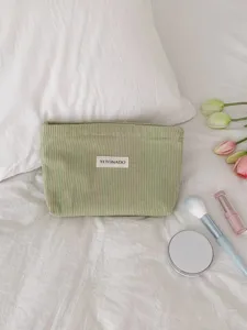 Green corduroy cosmetic bag detailed view, large capacity soft storage pouch for daily travel use.