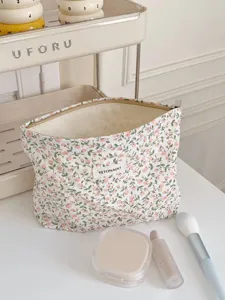 Detailed view of the floral cotton canvas makeup pouch, featuring a convenient zipper and vintage style.