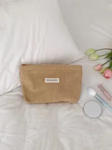 Corduroy cosmetic bag detail shot, large capacity portable makeup pouch, solid color toiletry bag.