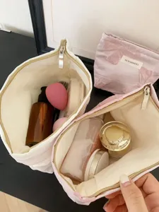 Vue détaillée de la trousse de maquillage nœud rétro avec grande capacité et fermeture éclair.