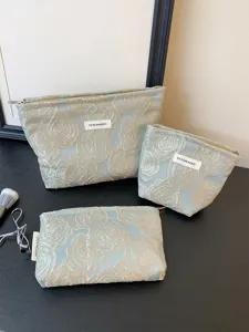 Embossed rose cosmetic bag set, large capacity portable makeup pouch and travel storage clutch.