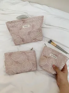 Embroidered rose cosmetic bag detail showing exquisite texture, large capacity for travel.