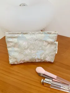 Detail view of the elegant jacquard butterfly makeup pouch, showcasing exquisite fabric texture.