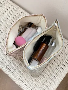 Detailed close-up of stylish floral cosmetic bags filled with daily makeup items.