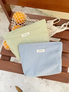Corduroy cosmetic bag detail, portable zipper pouch and solid color storage for daily use.