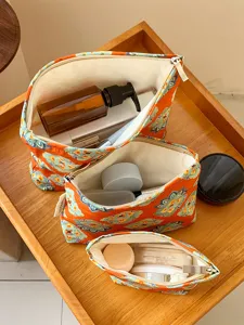 Ethnic floral makeup bag set detail, spacious canvas cosmetic pouch for travel toiletries.