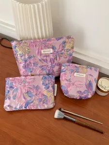 Purple floral embossed makeup pouch set, large capacity portable cosmetic organizer bag.