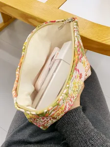 Canvas cosmetic bag with large capacity, floral print zipper pouch for travel and daily use.