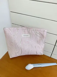 Embossed pink cosmetic bag with gold lines, large capacity portable toiletry storage bag.