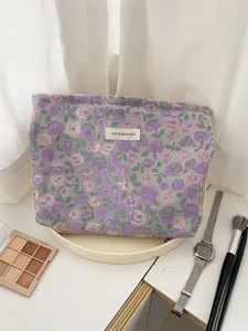 Detail view of purple floral jacquard cosmetic pouch, elegant fabric texture for travel use.