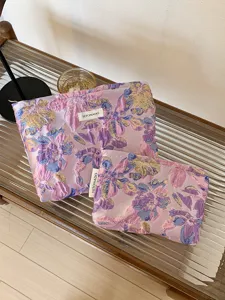 Purple floral jacquard cosmetic bag set, stylish portable travel makeup storage pouch.
