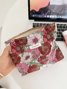 Detailed view of floral tapestry cosmetic pouch with zipper, vintage floral design makeup bag.