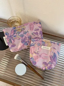Purple embossed floral cosmetic bag large capacity portable makeup pouch for travel use.