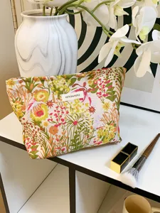 Detailed shot of a floral canvas cosmetic bag with zipper, stylish makeup storage pouch.