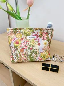 Detailed view of the embossed floral makeup pouch, stylish tapestry cosmetic storage bag for daily use.