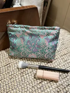 Detailed view of the vintage Chinese style brocade cosmetic bag with peony floral pattern.