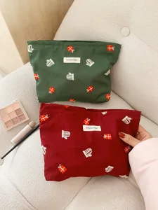 Detailed shot of Christmas embroidered cosmetic pouch, festive gift box and mitten embroidery pattern.