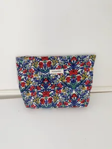 Detailed view of the vintage floral cosmetic bag fabric, showcasing the vivid pattern and zip.
