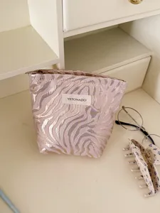 Embossed striped cosmetic bag, large capacity makeup storage pouch for travel and daily use.