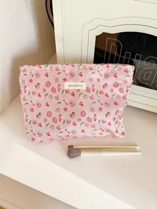 Floral cosmetic pouch detail view, pink fabric makeup bag featuring cute floral print design.