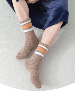Cozy brown fluffy fleece socks detail view, warm winter thermal mid-tube hosiery with stripes.