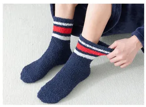 Detail view of thick men winter coral fleece sleep socks with cozy striped cuff design.