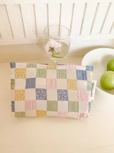 Pastel checkered floral makeup bag detail, portable cosmetic pouch for travel, aesthetic design.