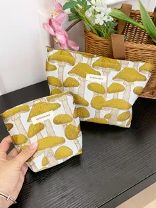 Detail view of cotton linen cosmetic bag set featuring charming yellow mushroom embroidery.