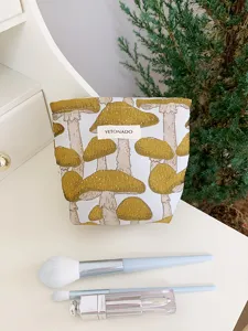 Close-up detail of the canvas cosmetic makeup bag featuring cute yellow mushroom embroidery.