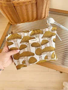 Canvas makeup pouch with cute yellow mushroom pattern, portable zipper storage bag.
