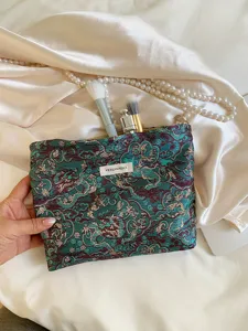 Large capacity dragon pattern cosmetic pouch with traditional brocade fabric for daily travel use.