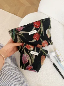 Detailed shot of vintage French tulip jacquard cosmetic bag and travel pouch with woven label.