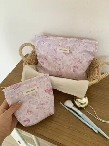 Detail view of floral cosmetic bag set, portable zipper pouch with woven fabric texture.