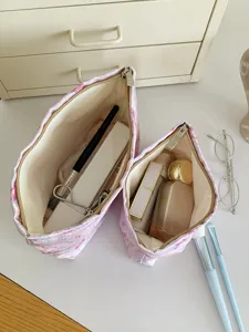 Detail view of large capacity pink cosmetic makeup bag showing interior storage and design.