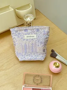 Floral jacquard makeup pouch, portable cosmetic storage bag, elegant toiletry organizer for travel.