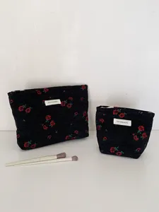 Detailed view of black woven rose cosmetic bags set with makeup brushes for daily use storage.