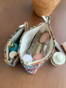 Close-up detail of the vintage floral embroidered cosmetic bag showing spacious storage capacity.