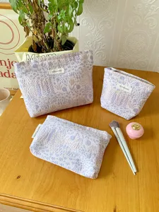Detail view of purple floral cosmetic bags set, elegant jacquard makeup pouch for daily use.