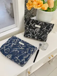 Detailed view of the floral makeup pouch featuring a large capacity and elegant canvas design.